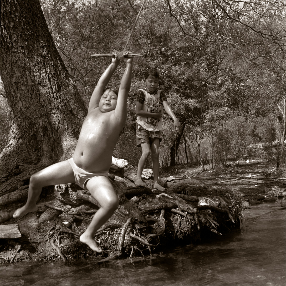 Kickapoo Boy Swinging_© James H. Evans